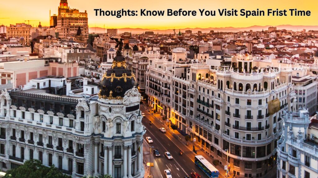 "A bustling street in Barcelona featuring vibrant buildings, outdoor cafés, and the iconic Sagrada Família in the background under a clear blue sky."